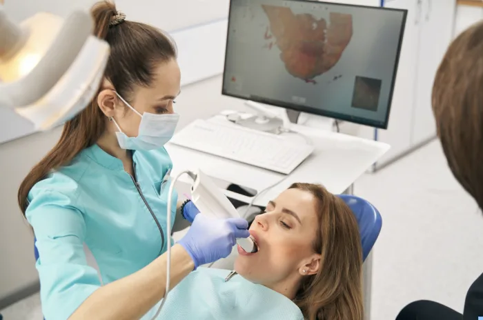 Patient in dental office getting scanned for modeless implants