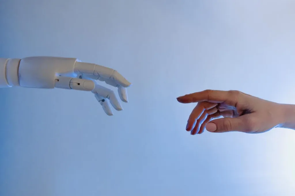 Robot and human hand reaching towards each other